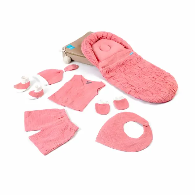 pink muslin baby set for newborn with baby nest, clothes, mittens, booties and bib.